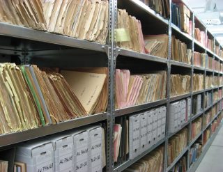 Rows of numbered files and folders stored on shelves